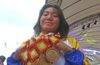 UST swimmer Patricia Mae Santor of the National Capital Region proudly displays her seven Palarong Pambansa gold medals on Friday in Agusan del Sur.