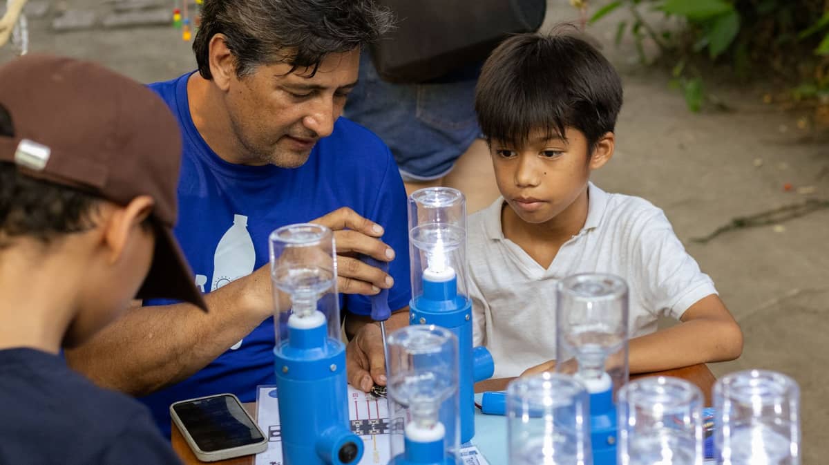 KIDS building solar power lights with Illac Diaz of Liter of Light.