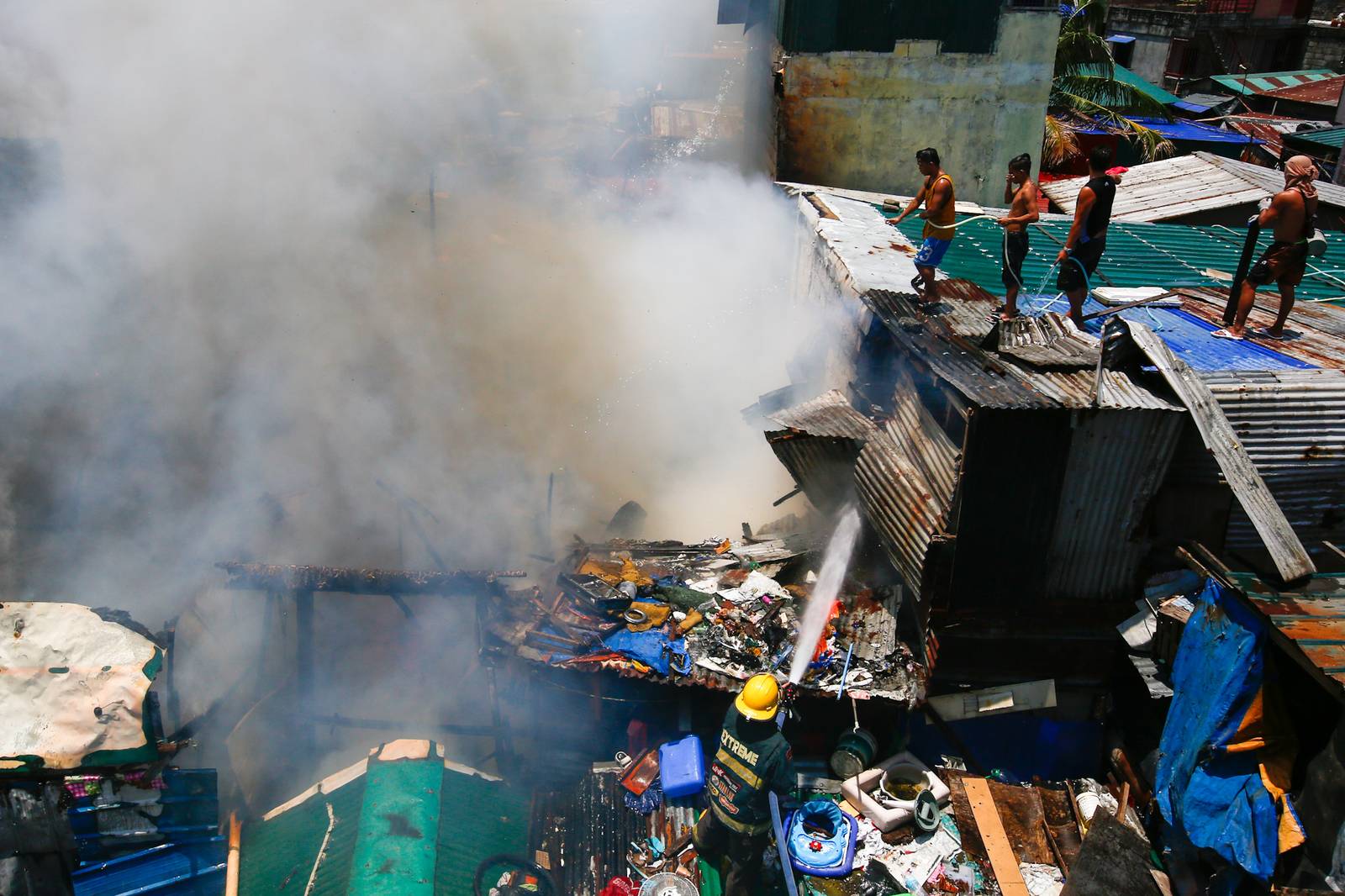 Firefighters and residents work together to control a raging third-alarm fire at the Baseco Compound in Port Area, Manila, on 30 May 2026. The incident comes just a week after a separate blaze gutted a nearby coastal community across the Pasig River.