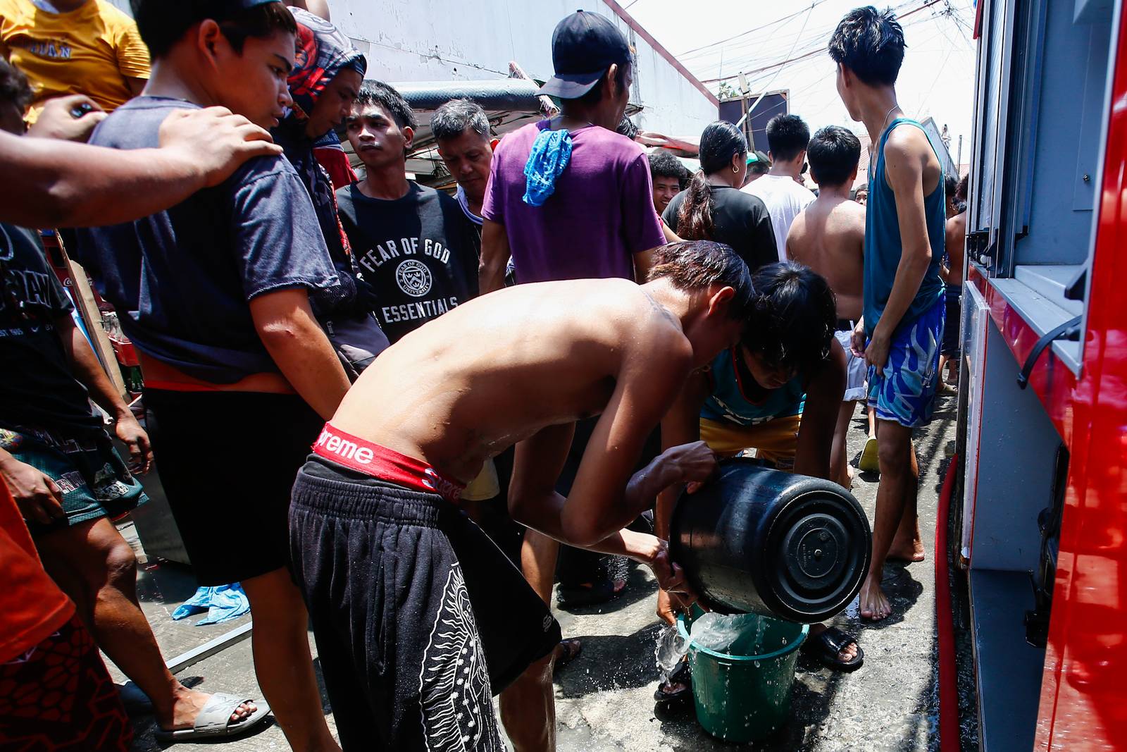 Firefighters and residents work together to control a raging third-alarm fire at the Baseco Compound in Port Area, Manila, on 30 May 2026. The incident comes just a week after a separate blaze gutted a nearby coastal community across the Pasig River.