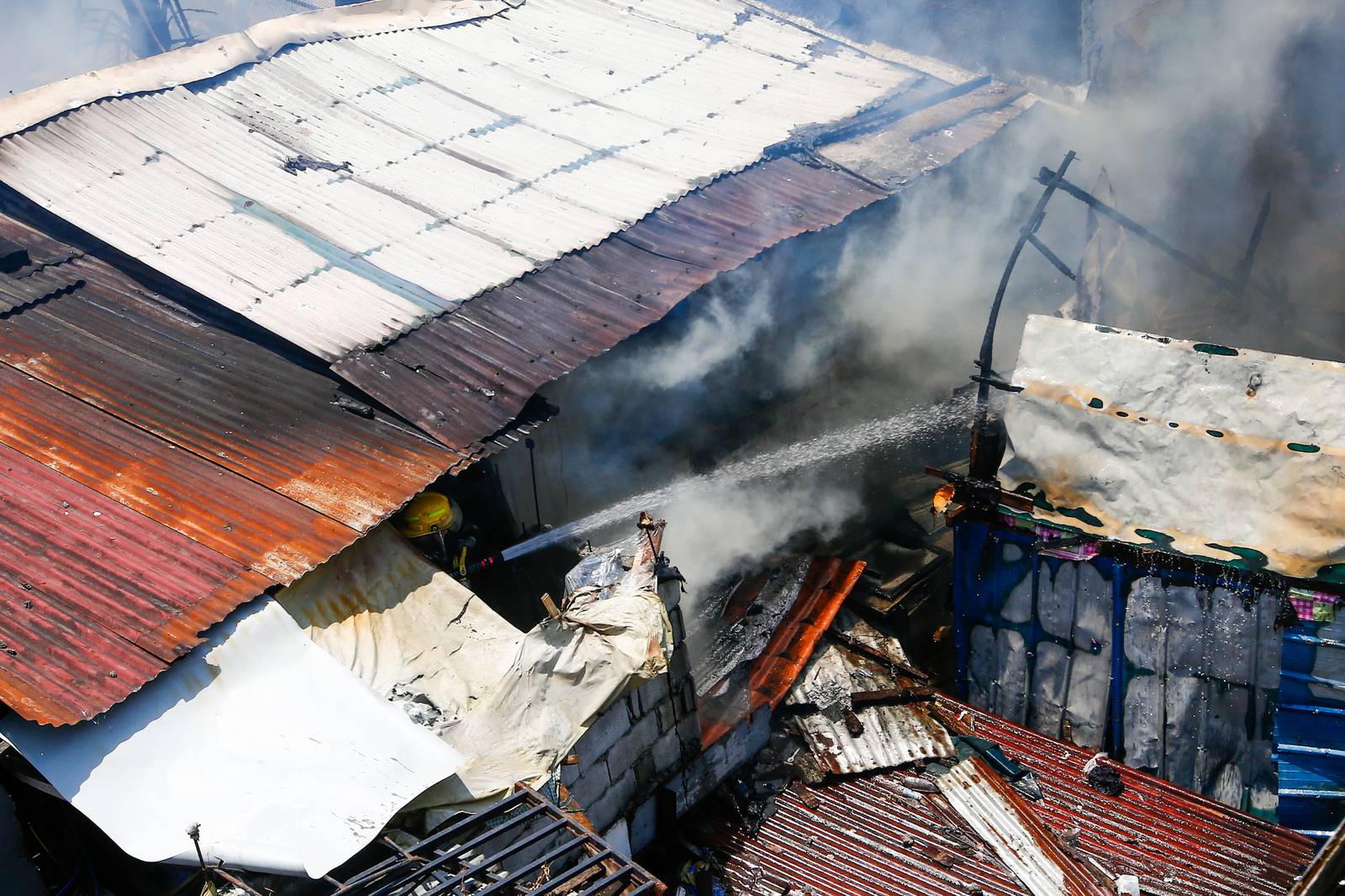 Firefighters and residents work together to control a raging third-alarm fire at the Baseco Compound in Port Area, Manila, on 30 May 2026. The incident comes just a week after a separate blaze gutted a nearby coastal community across the Pasig River.