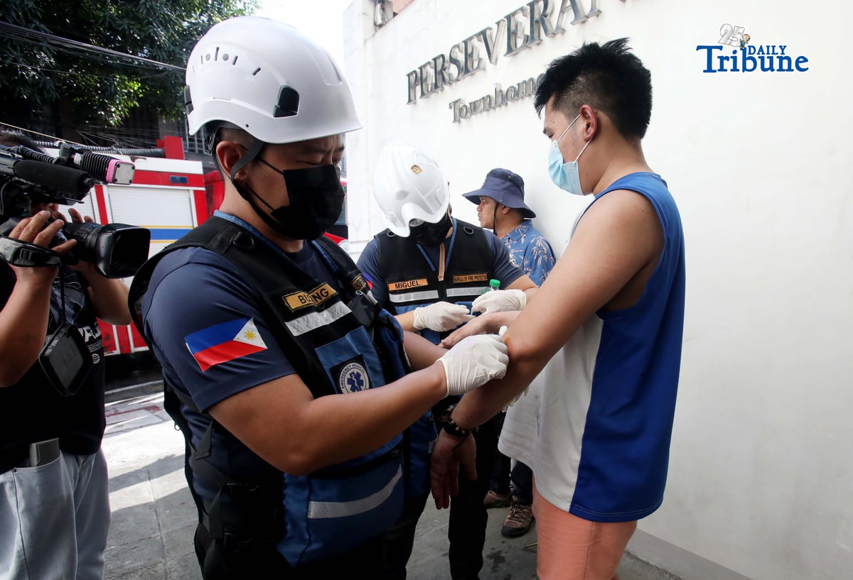 (May 30 2026)  Bureau of Fire Protection, Emergency Medical Services (BFP- EMS). Personnel providing first aid to the  first degree burn to  the one of the injured from the first alarm fire at Maningning corner Maamo street in Quezon City, on Saturday  May 30 2026. Photo/Analy Labor