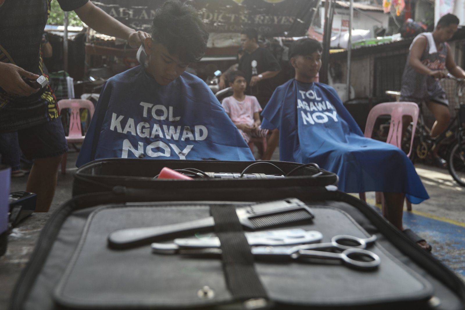 Members of the Triskelion Grand Fraternity jumpstarted a back-to-school free haircut outreach program at Kamias Extension, Quezon City on Sunday, 31 May, 2026. Thirty community students for the upcoming school year have been provided with haircuts along the community covered court.| Aram Lascano