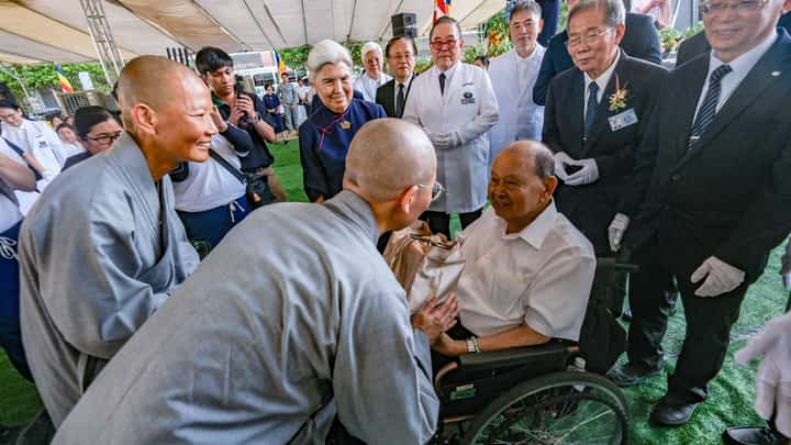 BUDDHIST nuns representing Tzu Chi Foundation in Taiwan greet Liwayway Group chairman Carlos Chan (in wheelchair), whose family donated the land where the Tzu Chi Imus Eye Center will rise.
