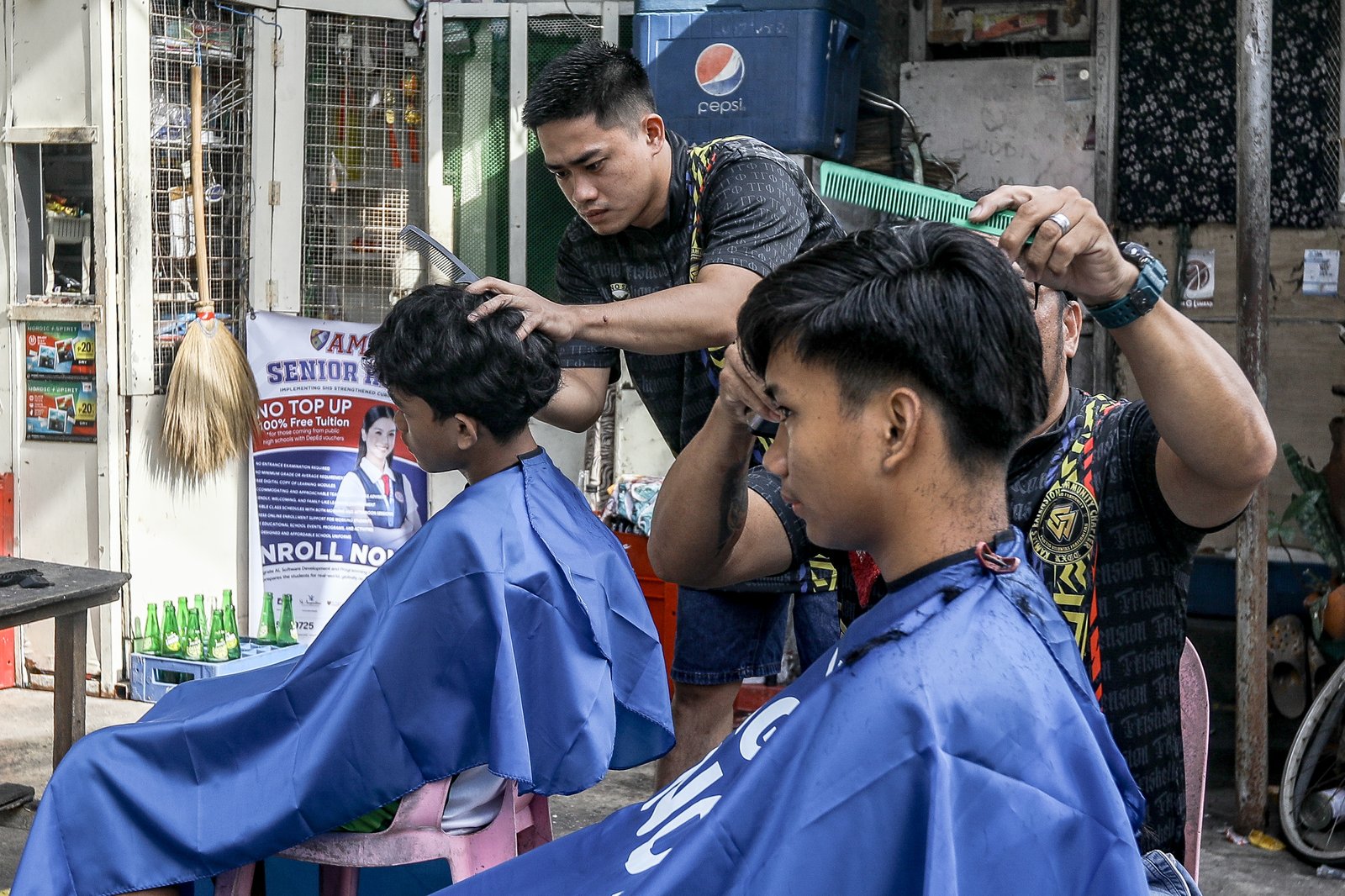 Members of the Triskelion Grand Fraternity jumpstarted a back-to-school free haircut outreach program at Kamias Extension, Quezon City on Sunday, 31 May, 2026. Thirty community students for the upcoming school year have been provided with haircuts along the community covered court.| Aram Lascano