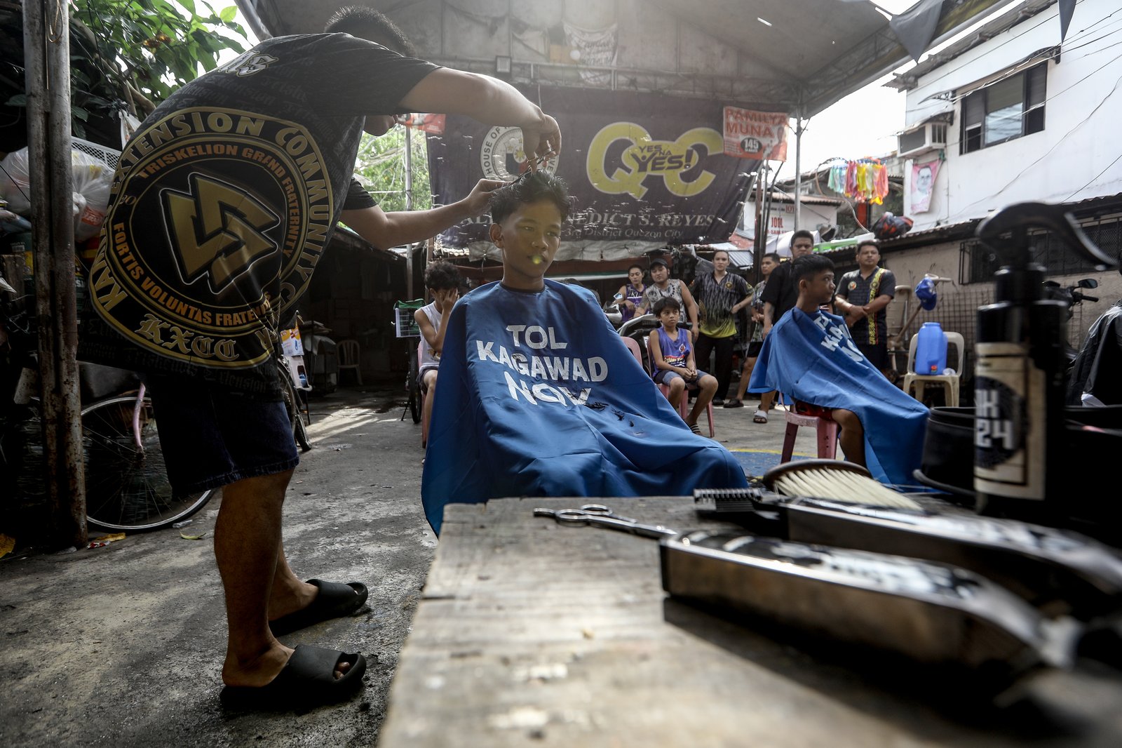 Members of the Triskelion Grand Fraternity jumpstarted a back-to-school free haircut outreach program at Kamias Extension, Quezon City on Sunday, 31 May, 2026. Thirty community students for the upcoming school year have been provided with haircuts along the community covered court.| Aram Lascano
