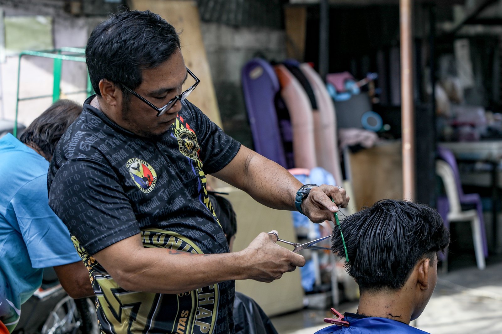 Members of the Triskelion Grand Fraternity jumpstarted a back-to-school free haircut outreach program at Kamias Extension, Quezon City on Sunday, 31 May, 2026. Thirty community students for the upcoming school year have been provided with haircuts along the community covered court.| Aram Lascano
