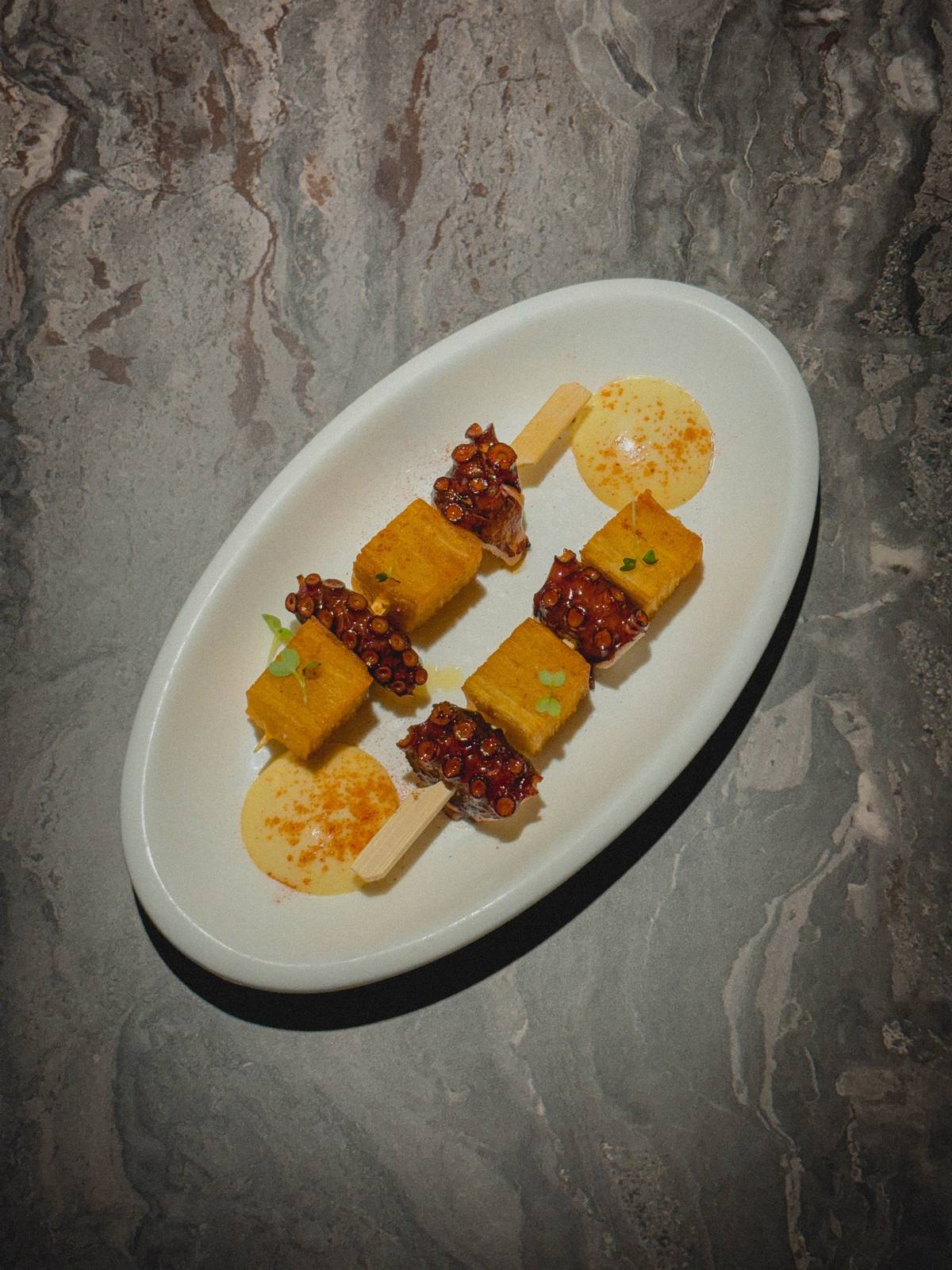 PULPO and potato pave are a tasty bite that pairs well with any of the libations served at the bar