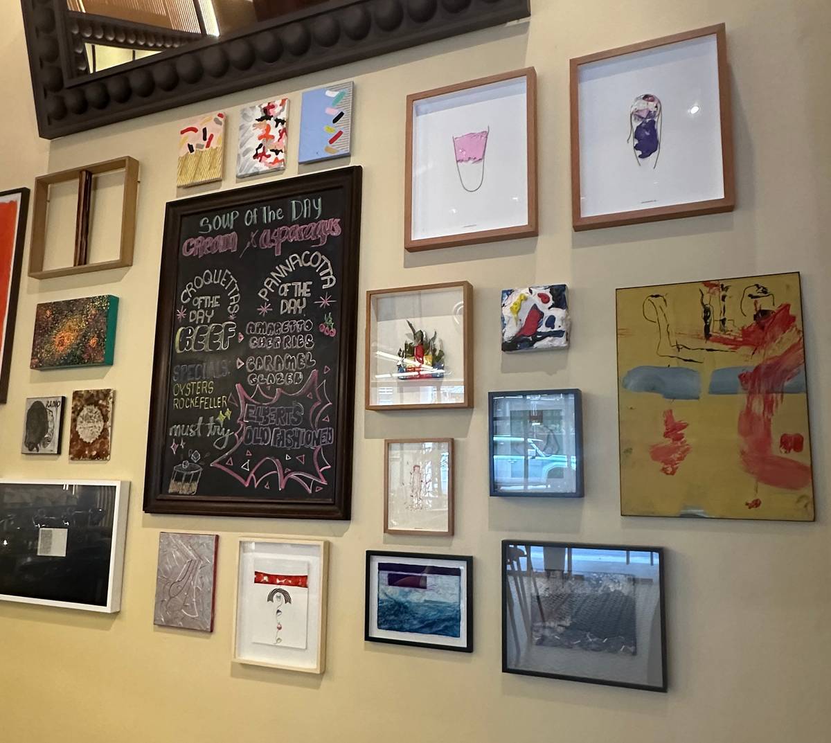 ADDING contrast and tension to the cozy feel is the gallery wall bedecked with modern art.