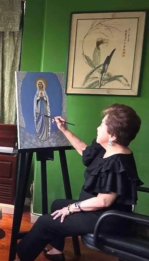CAROLINA Llanillo paints finishing touches on one of her 20 Mama Mary paintings in time for the Marian art exhibit in September.