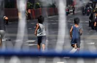 CHILDREN play along a portion of Recto Avenue in Manila amid the barricades and razor wires as the road was closed to prevent motorists from using the road.