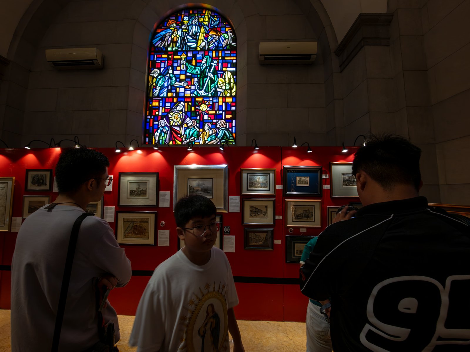 Visitors immerse themselves in history at the Manila in Prints exhibition, held at the Manila Cathedral on 14 June 2026. The display features rare antique prints, historical maps, and archival materials highlighting the rich heritage of the cathedral, the Walled City - Intramuros, and greater Manila.
