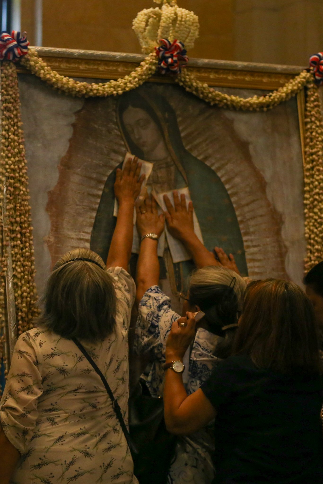 Catholic devotees line up before the images of Our Lady of Guadalupe and St. Juan Diego at the Manila Cathedral in Intramuros, Manila on 14 June 2026. The replica, sent to the Philippines from Mexico, will remain at the cathedral until 18 June before traveling to churches across Luzon, Visayas, and Mindanao until December 2026.
