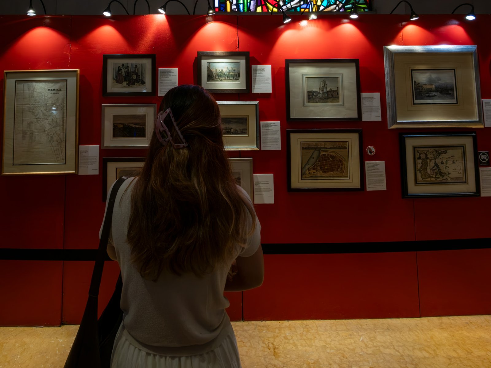 Visitors immerse themselves in history at the Manila in Prints exhibition, held at the Manila Cathedral on 14 June 2026. The display features rare antique prints, historical maps, and archival materials highlighting the rich heritage of the cathedral, the Walled City - Intramuros, and greater Manila.