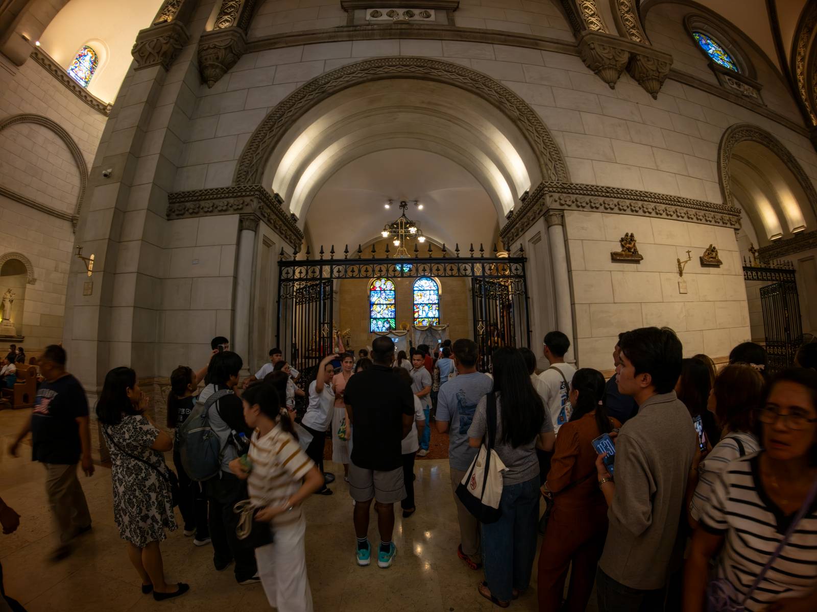 Catholic devotees line up before the images of Our Lady of Guadalupe and St. Juan Diego at the Manila Cathedral in Intramuros, Manila on 14 June 2026. The replica, sent to the Philippines from Mexico, will remain at the cathedral until 18 June before traveling to churches across Luzon, Visayas, and Mindanao until December 2026.