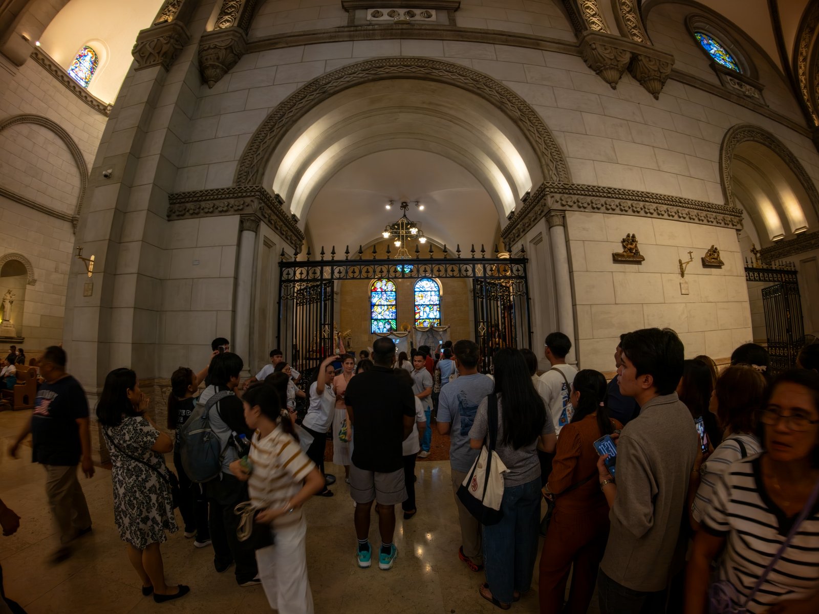 Catholic devotees line up before the images of Our Lady of Guadalupe and St. Juan Diego at the Manila Cathedral in Intramuros, Manila on 14 June 2026. The replica, sent to the Philippines from Mexico, will remain at the cathedral until 18 June before traveling to churches across Luzon, Visayas, and Mindanao until December 2026.