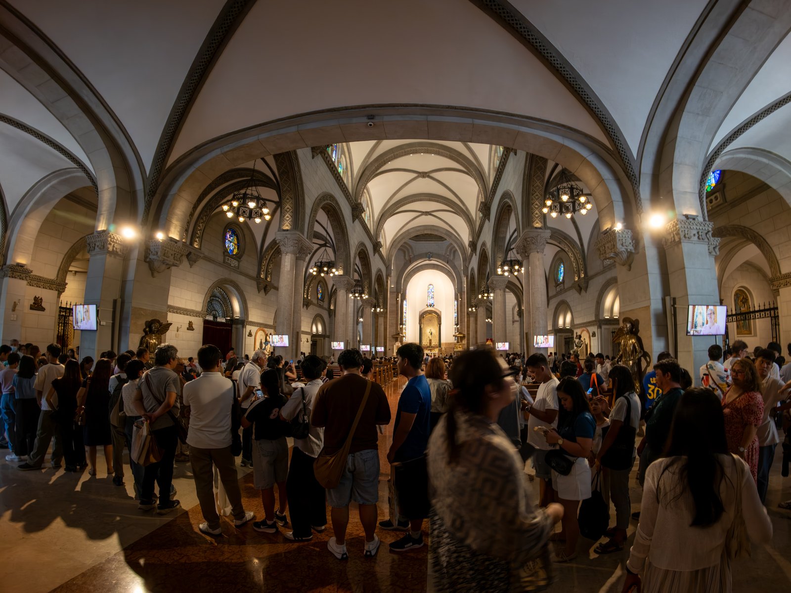 Catholic devotees line up before the images of Our Lady of Guadalupe and St. Juan Diego at the Manila Cathedral in Intramuros, Manila on 14 June 2026. The replica, sent to the Philippines from Mexico, will remain at the cathedral until 18 June before traveling to churches across Luzon, Visayas, and Mindanao until December 2026.