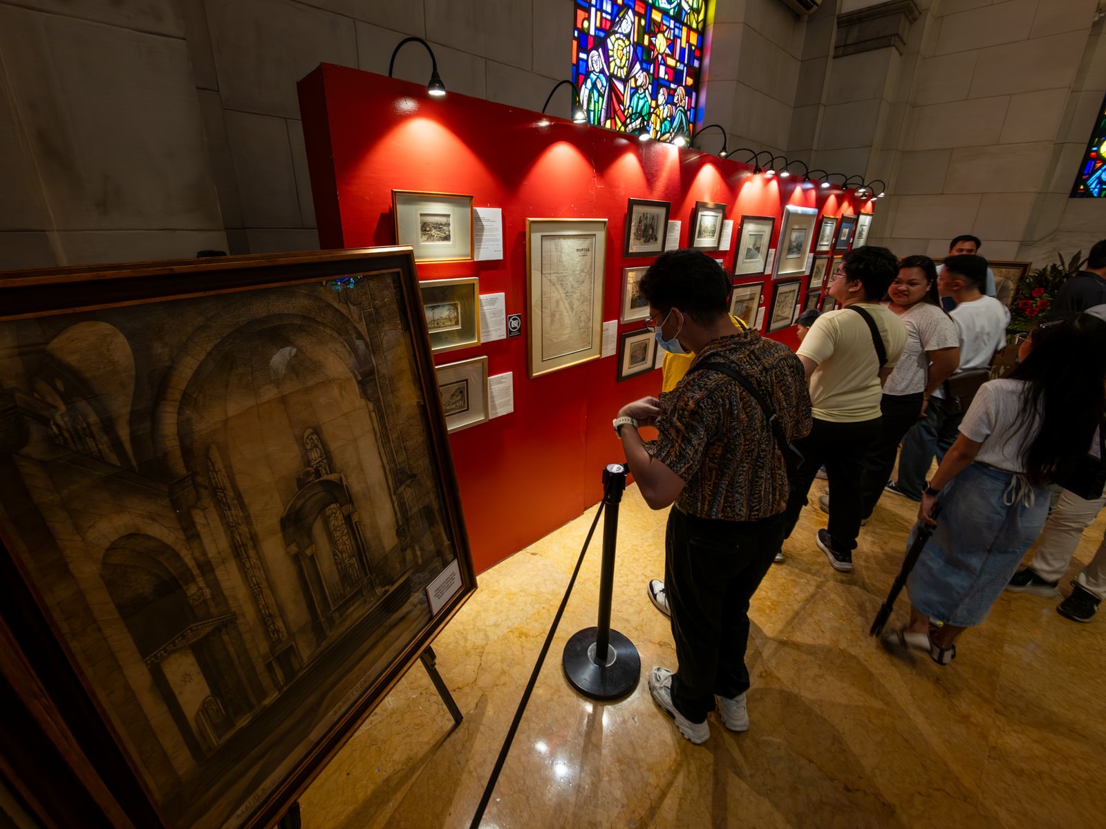 Visitors immerse themselves in history at the Manila in Prints exhibition, held at the Manila Cathedral on 14 June 2026. The display features rare antique prints, historical maps, and archival materials highlighting the rich heritage of the cathedral, the Walled City - Intramuros, and greater Manila.
