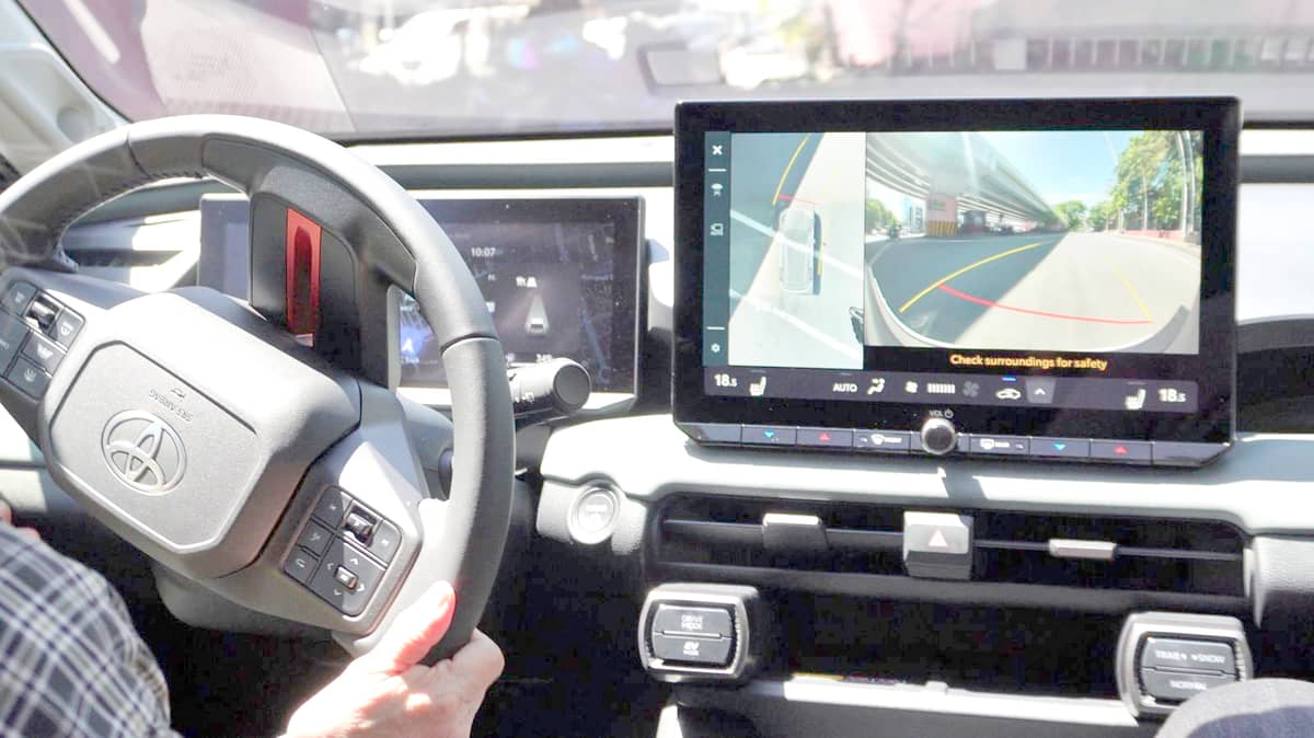 AT the wheel.