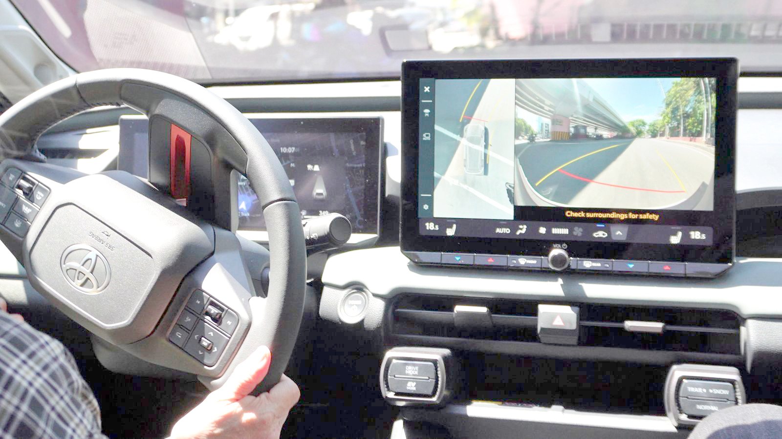 AT the wheel.
