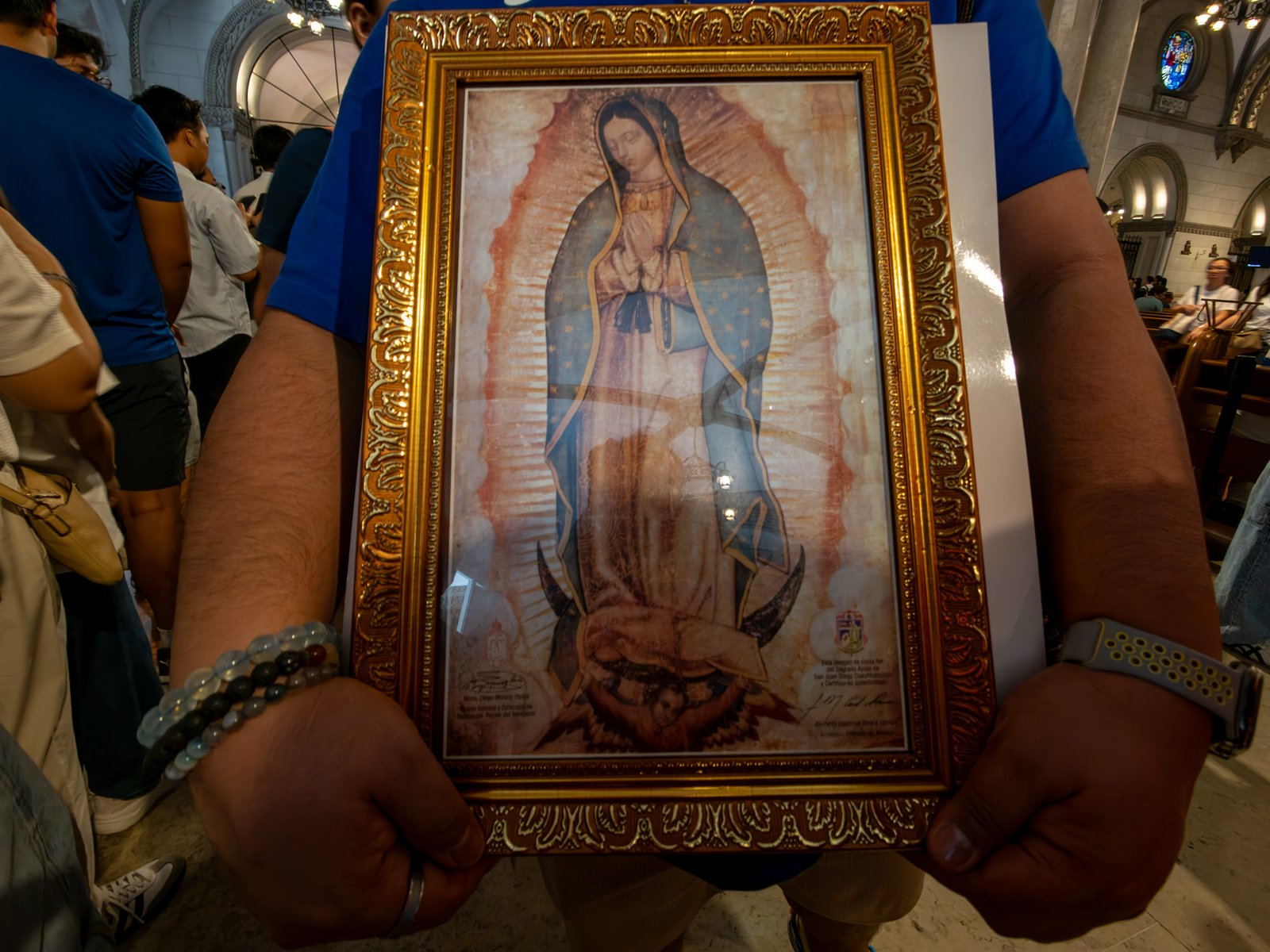 Catholic devotees line up before the images of Our Lady of Guadalupe and St. Juan Diego at the Manila Cathedral in Intramuros, Manila on 14 June 2026. The replica, sent to the Philippines from Mexico, will remain at the cathedral until 18 June before traveling to churches across Luzon, Visayas, and Mindanao until December 2026.