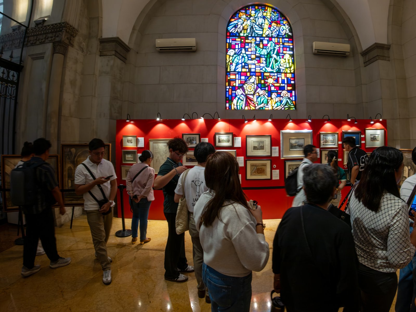 Visitors immerse themselves in history at the Manila in Prints exhibition, held at the Manila Cathedral on 14 June 2026. The display features rare antique prints, historical maps, and archival materials highlighting the rich heritage of the cathedral, the Walled City - Intramuros, and greater Manila.