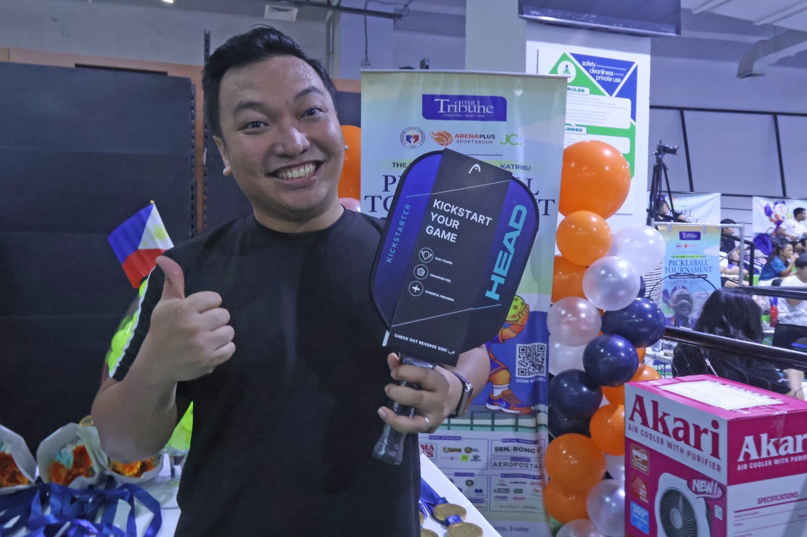 LORENZ Christian Baniel flashes a thumbs-up after winning a brand-new pickleball paddle.