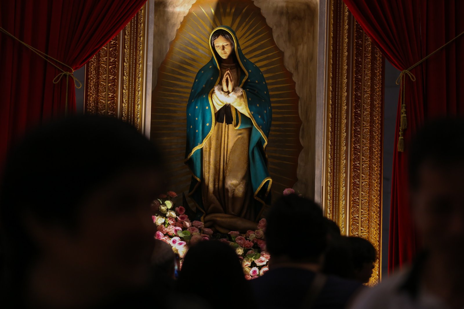 Catholic devotees line up before the images of Our Lady of Guadalupe and St. Juan Diego at the Manila Cathedral in Intramuros, Manila on 14 June 2026. The replica, sent to the Philippines from Mexico, will remain at the cathedral until 18 June before traveling to churches across Luzon, Visayas, and Mindanao until December 2026.