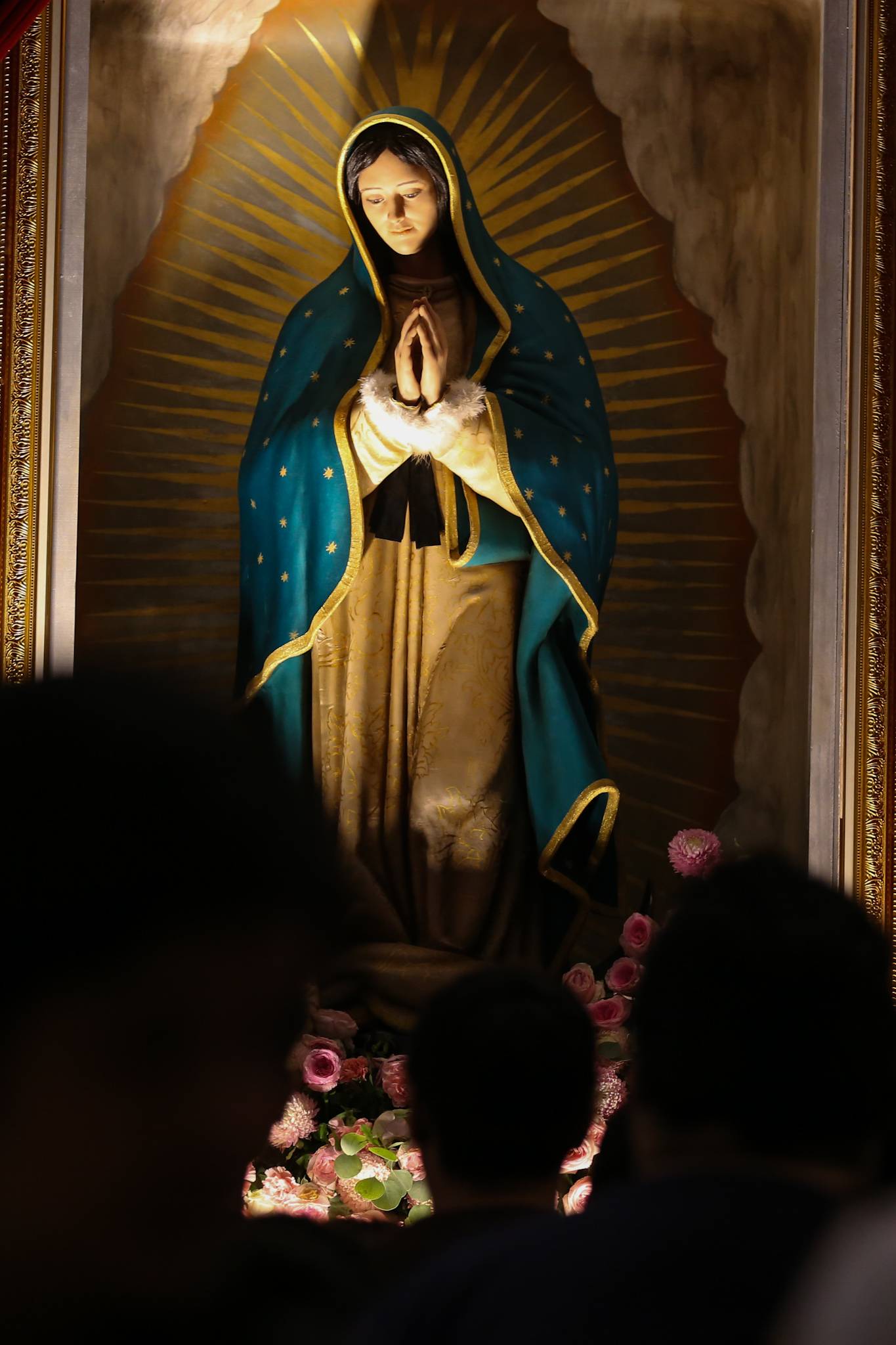 Catholic devotees line up before the images of Our Lady of Guadalupe and St. Juan Diego at the Manila Cathedral in Intramuros, Manila on 14 June 2026. The replica, sent to the Philippines from Mexico, will remain at the cathedral until 18 June before traveling to churches across Luzon, Visayas, and Mindanao until December 2026.