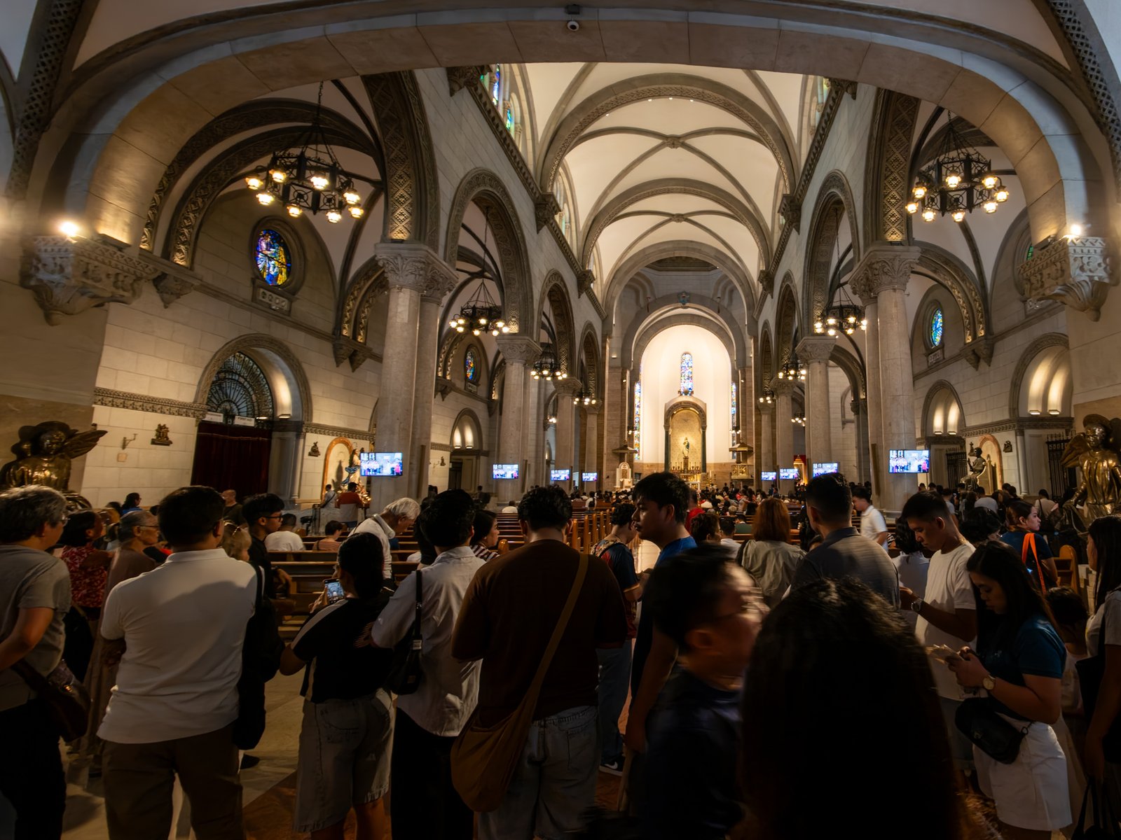 Catholic devotees line up before the images of Our Lady of Guadalupe and St. Juan Diego at the Manila Cathedral in Intramuros, Manila on 14 June 2026. The replica, sent to the Philippines from Mexico, will remain at the cathedral until 18 June before traveling to churches across Luzon, Visayas, and Mindanao until December 2026.