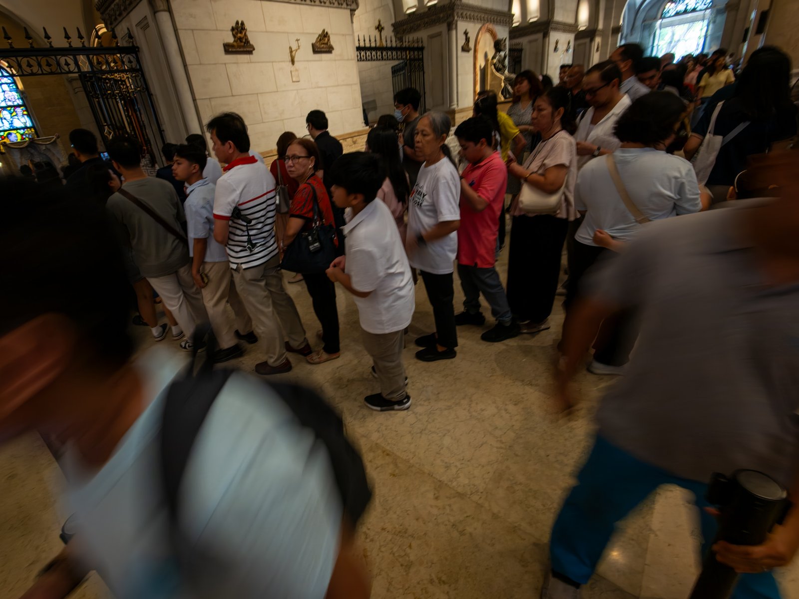 Catholic devotees line up before the images of Our Lady of Guadalupe and St. Juan Diego at the Manila Cathedral in Intramuros, Manila on 14 June 2026. The replica, sent to the Philippines from Mexico, will remain at the cathedral until 18 June before traveling to churches across Luzon, Visayas, and Mindanao until December 2026.