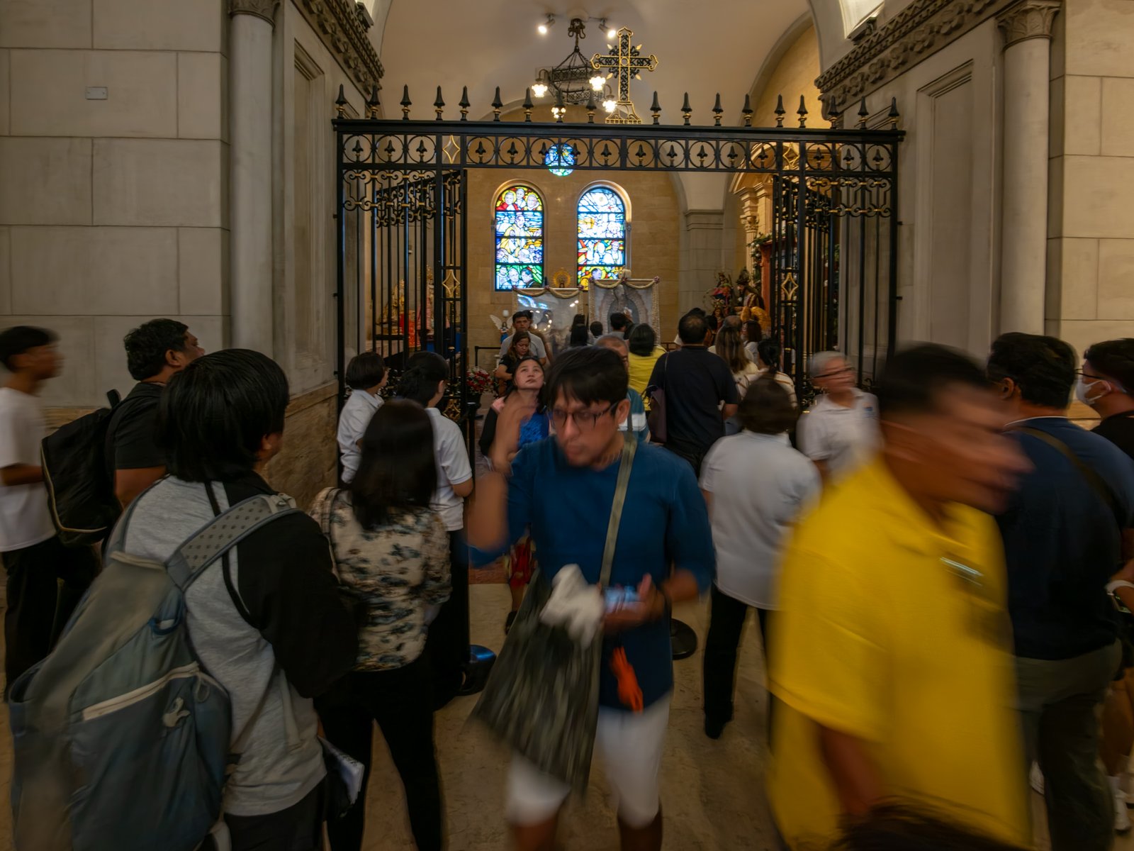 Catholic devotees line up before the images of Our Lady of Guadalupe and St. Juan Diego at the Manila Cathedral in Intramuros, Manila on 14 June 2026. The replica, sent to the Philippines from Mexico, will remain at the cathedral until 18 June before traveling to churches across Luzon, Visayas, and Mindanao until December 2026.