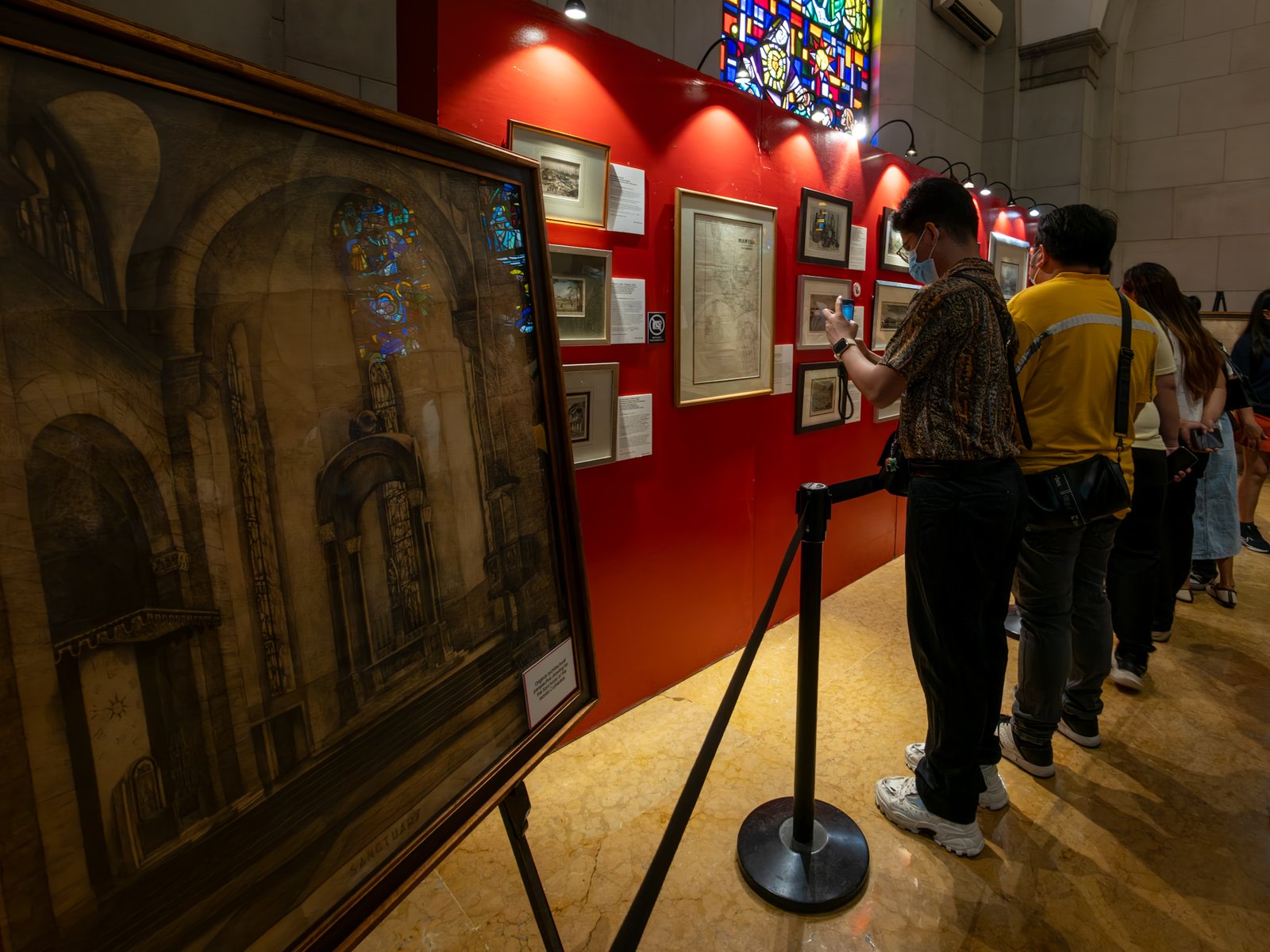 Visitors immerse themselves in history at the Manila in Prints exhibition, held at the Manila Cathedral on 14 June 2026. The display features rare antique prints, historical maps, and archival materials highlighting the rich heritage of the cathedral, the Walled City - Intramuros, and greater Manila.