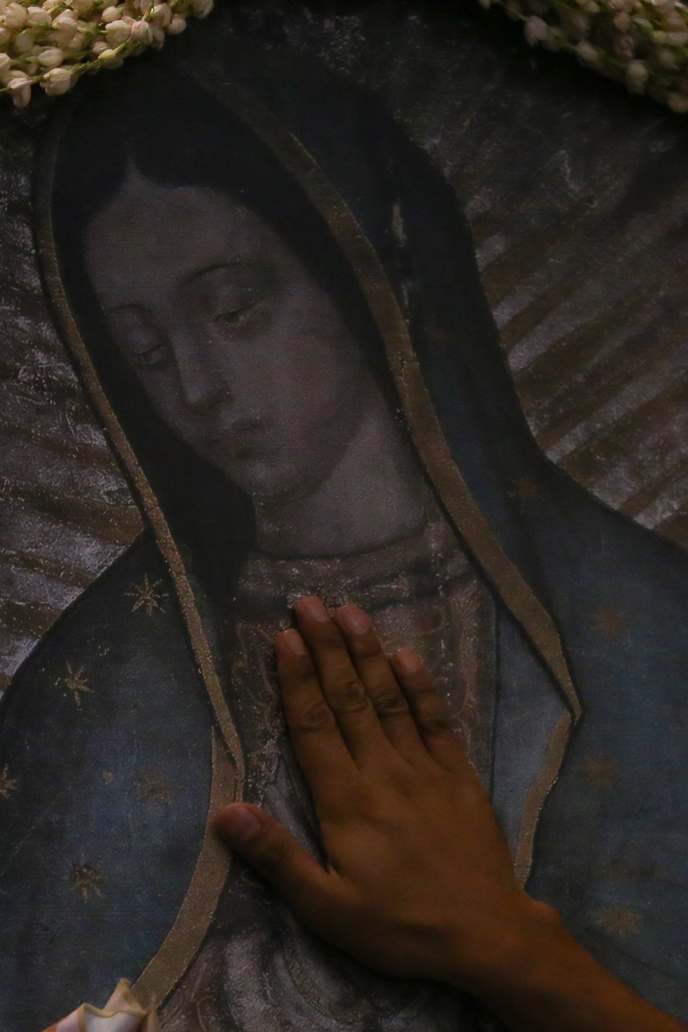 Catholic devotees line up before the images of Our Lady of Guadalupe and St. Juan Diego at the Manila Cathedral in Intramuros, Manila on 14 June 2026. The replica, sent to the Philippines from Mexico, will remain at the cathedral until 18 June before traveling to churches across Luzon, Visayas, and Mindanao until December 2026.
