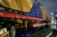 A TRAILER truck sits crushed after slamming into a stalled vehicle on the southbound lane of the C5-Ortigas Flyover late Saturday night. The crash claimed the life of a truck helper, who remained trapped inside the mangled cab for more than three hours before rescue teams could extricate him.