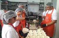 VOLUNTEERS from Solaire Cares prepare hot meals for children of Barangay San Dionisio, Paranaque City.