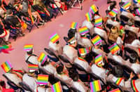 LGBTIQ+ graduates wear rainbow-colored caps and sashes as they take part in the special commencement ceremony.