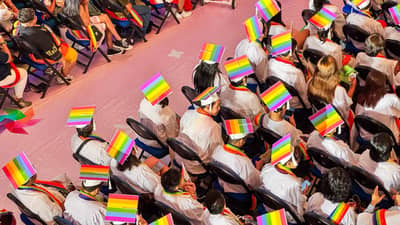 LGBTIQ+ graduates wear rainbow-colored caps and sashes as they take part in the special commencement ceremony.
