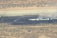 SMOKE rises from a blackened part of Edwards Air Force Base after the crash of a US Air Force B-52 bomber aircraft in Edwards, California, US, in a still image from news helicopter video.
