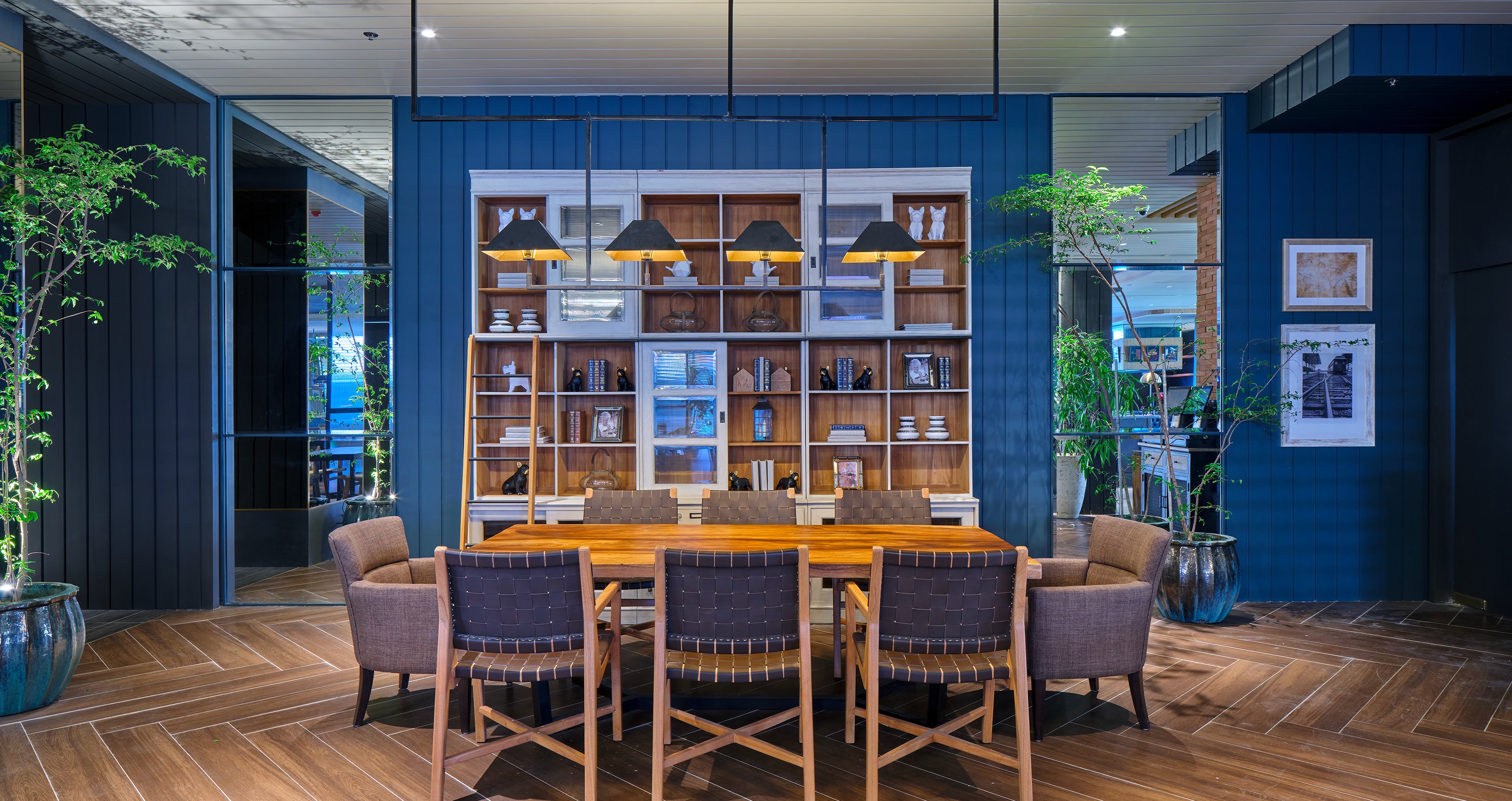 DINING area with a rustic wooden table and blue paneled walls.