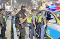 POLICE investigators process the scene along the National Road in Barangay Putatan, Muntinlupa City, where an armed disturbance suspect was shot and killed Tuesday night. The suspect was shot by backup officers in self-defense after he allegedly struck a responding policeman in the head with a stone and advanced toward him with an improvised ice pick.