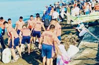 VOLUNTEERS from SM City Batangas clean the coast.