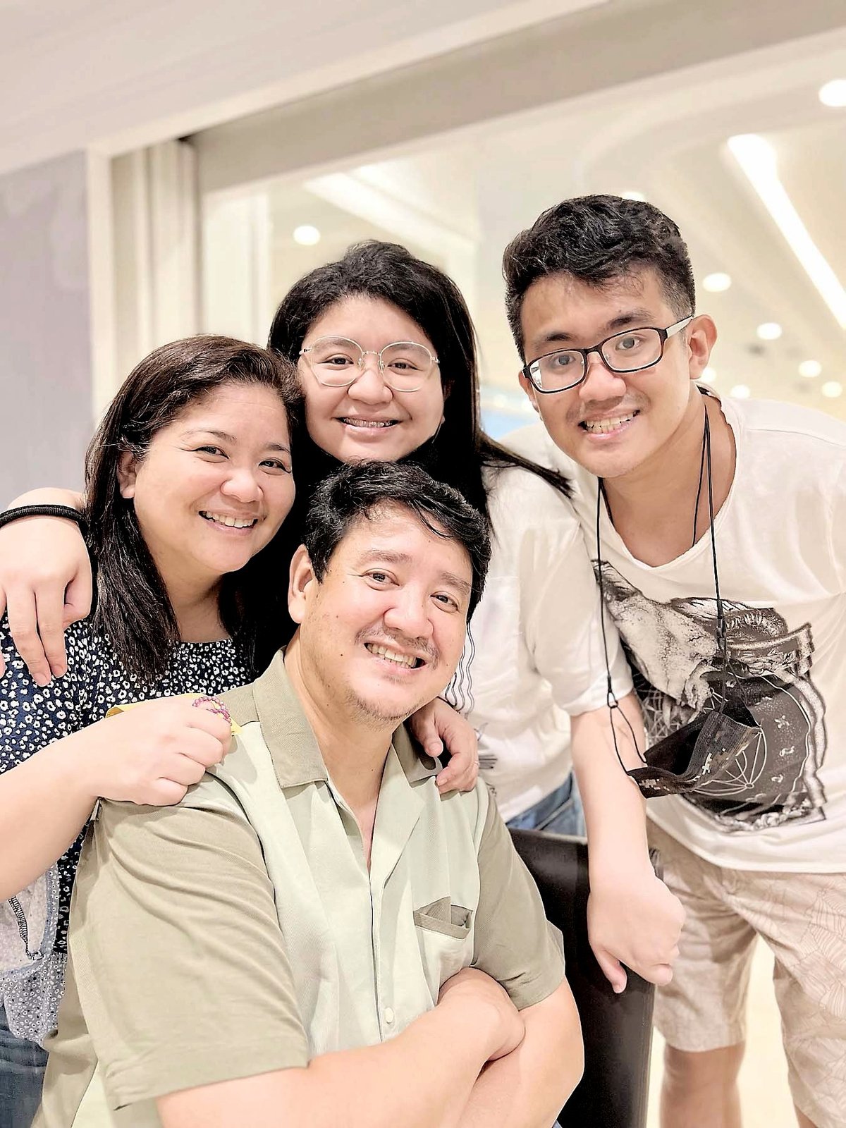FAMILY first Louella Mangcucang poses with her children and husband, Dennis, in a portrait of love and togetherness.