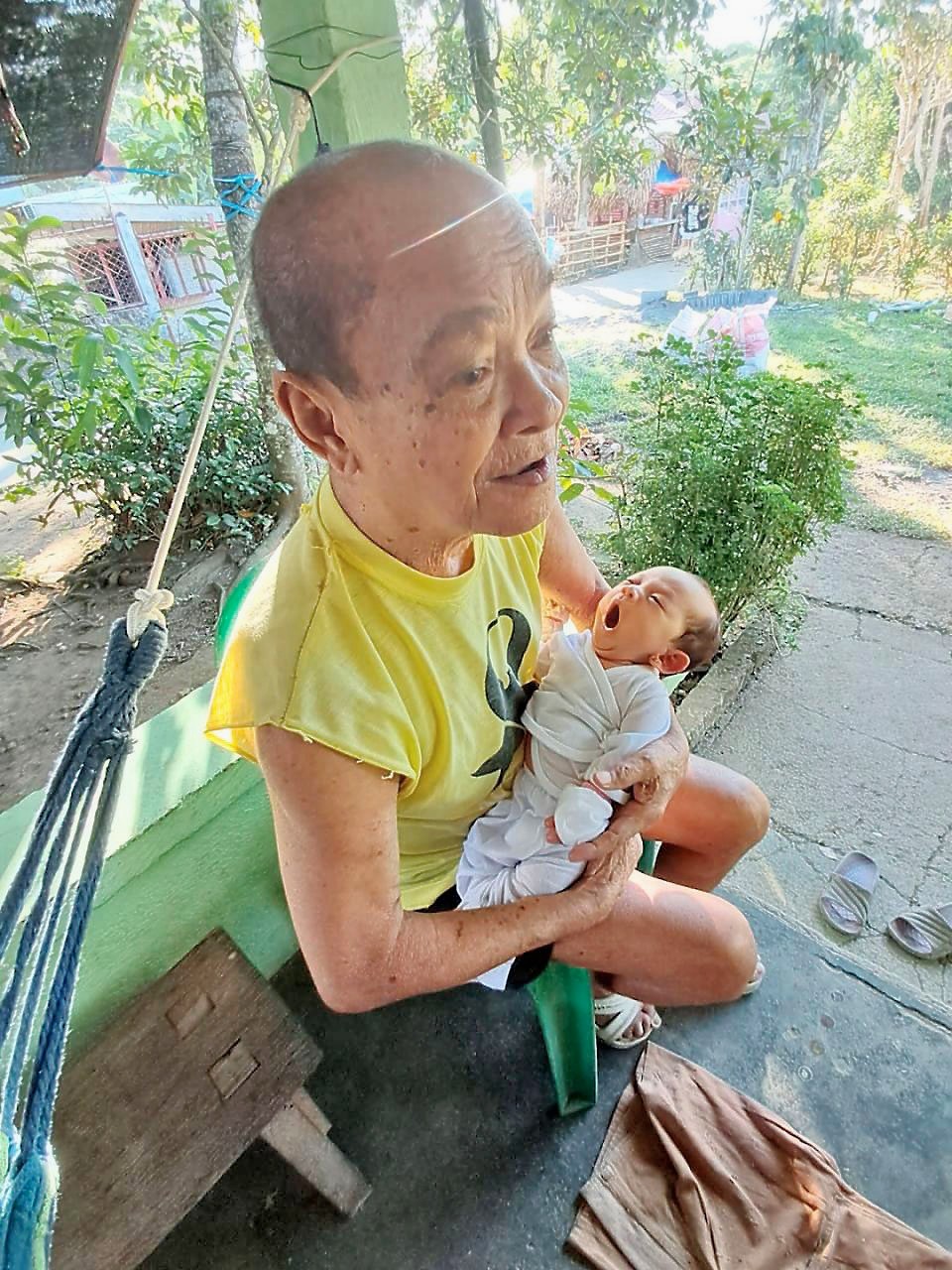 PROUD lolo Elizalde Ayeng Sr. cradles his great-grandchild, Raffa, bridging generations with a loving embrace.