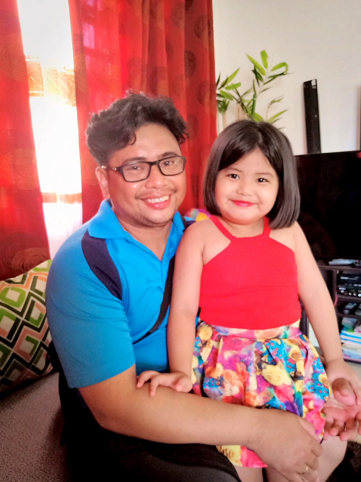 FATHER and child Gene Galvan shares a tender moment with her daughter.