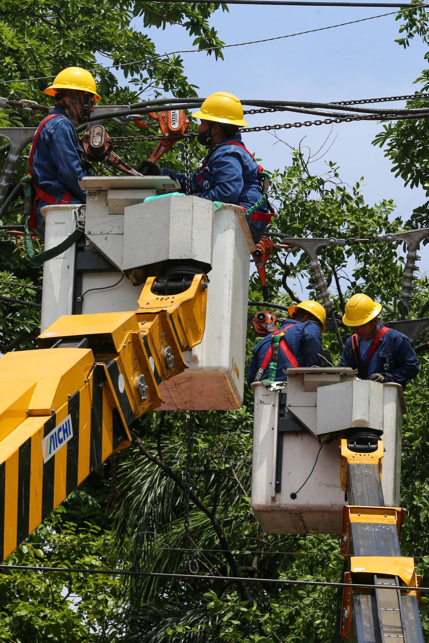 Workers from Meralco repair downed power lines in Malabon City on 22 June 2026, following a severe downpour the previous evening. Sudden strong winds and heavy rains caused three electrical posts to topple, cutting off electricity, phone lines, and internet services for local residents.
