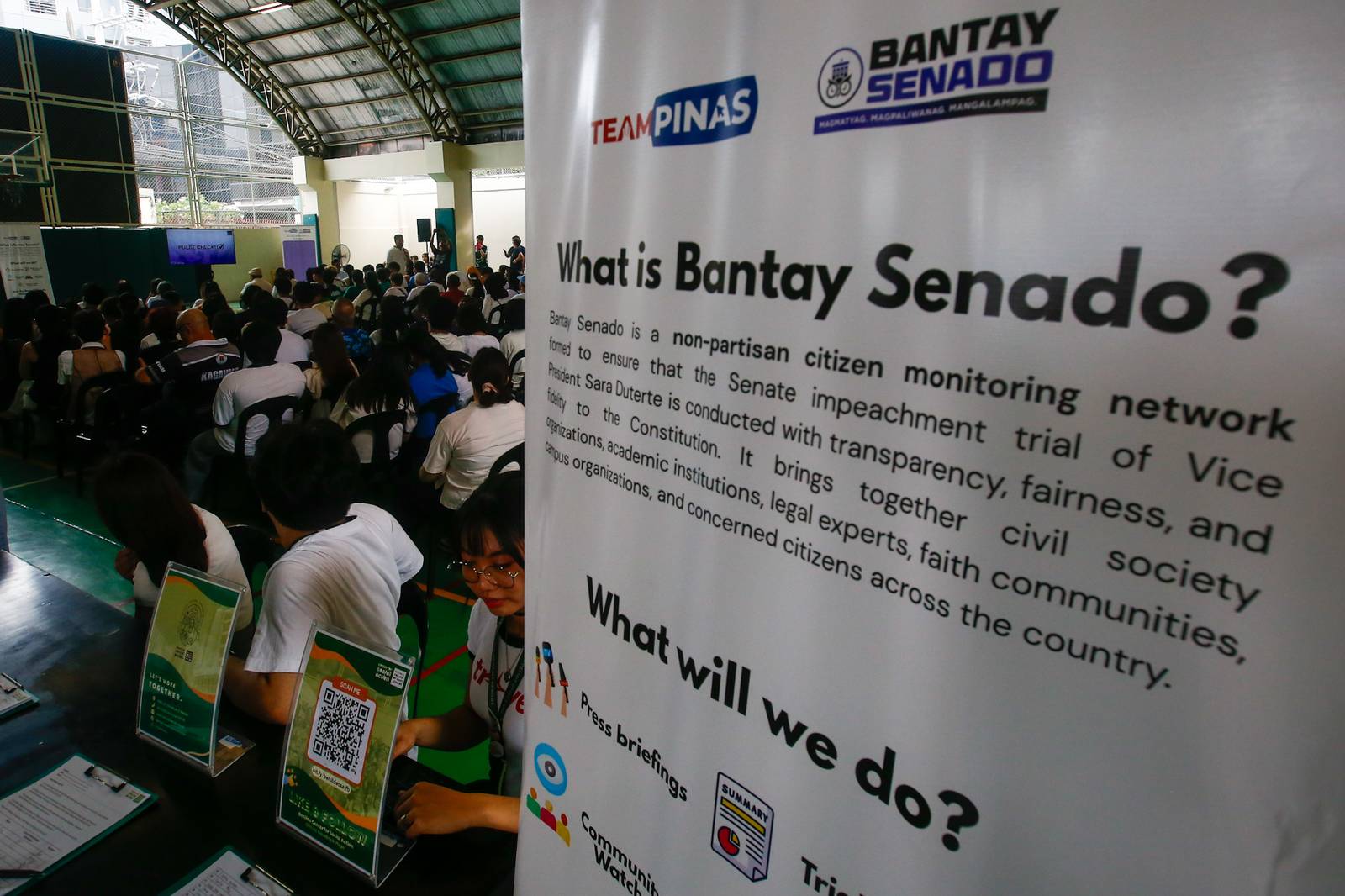 Students, workers, civil society groups, and community leaders gather for a public forum at the Sandejas Gym in De La Salle-College of Saint Benilde (DLS-CSB), Manila on 23 June 2026. Organized by Bantay Senado, the Center for Social Action, and the School of Diplomacy and Governance, the forum aims to provide local leaders with a shared, accurate, and process-based understanding of the current impeachment proceedings and upcoming developments.