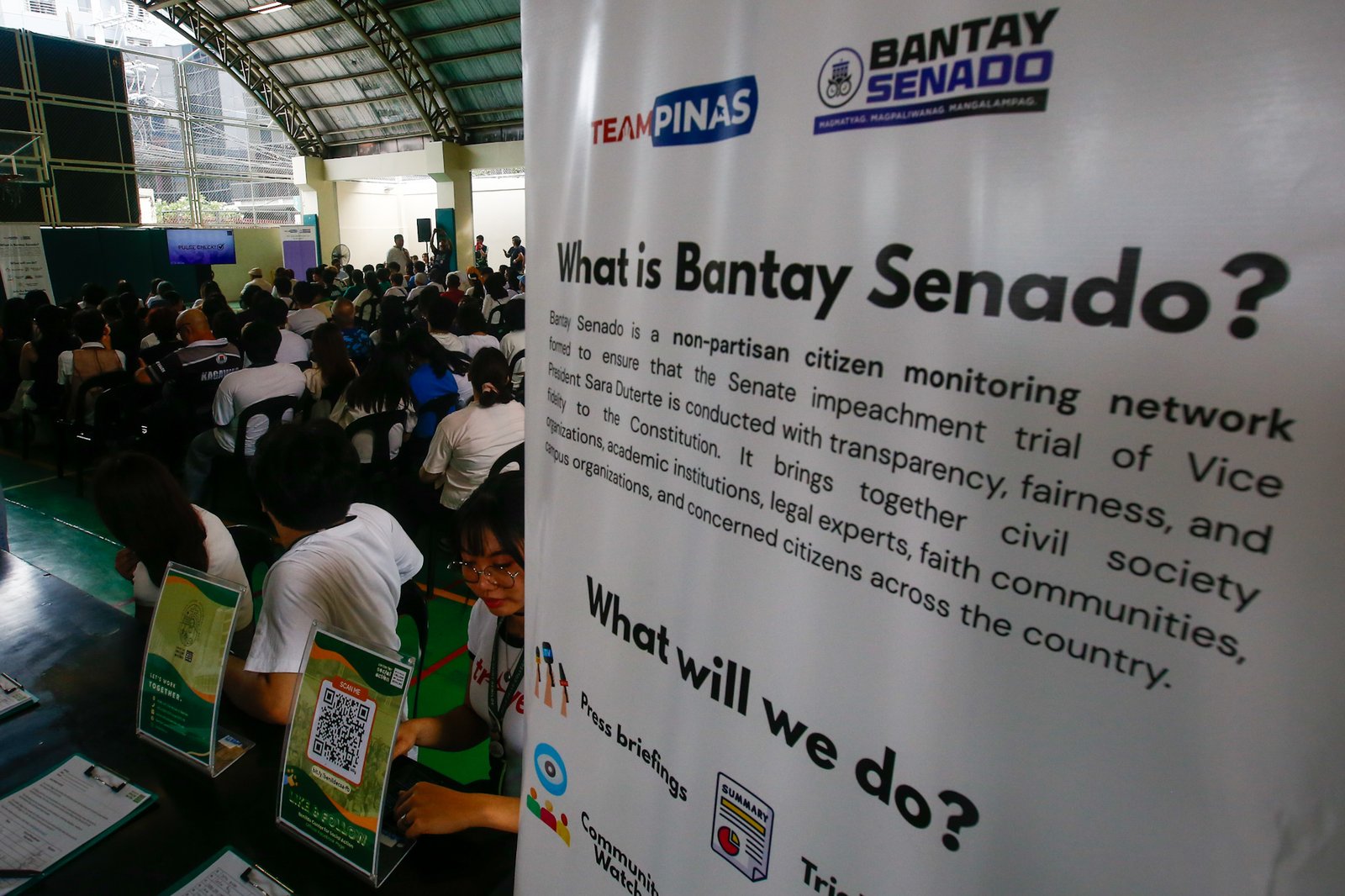 Students, workers, civil society groups, and community leaders gather for a public forum at the Sandejas Gym in De La Salle-College of Saint Benilde (DLS-CSB), Manila on 23 June 2026. Organized by Bantay Senado, the Center for Social Action, and the School of Diplomacy and Governance, the forum aims to provide local leaders with a shared, accurate, and process-based understanding of the current impeachment proceedings and upcoming developments.