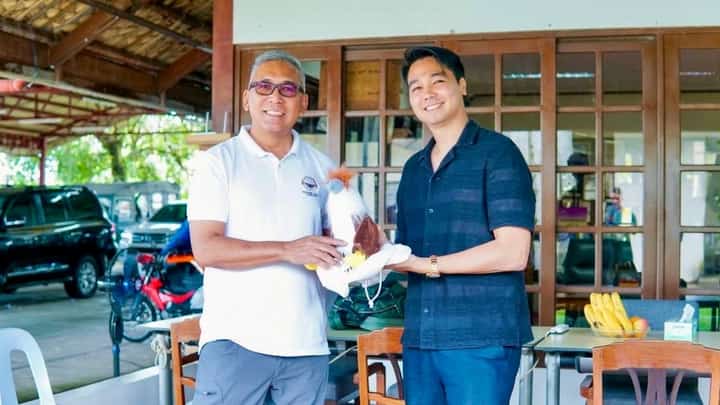 PEF Executive Director Dennis Salvador and Javier Mayor Michael Dragon Javier, share a light moment with a Philippine Eagle plush, symbolizing their shared support for conservation efforts in Leyte.