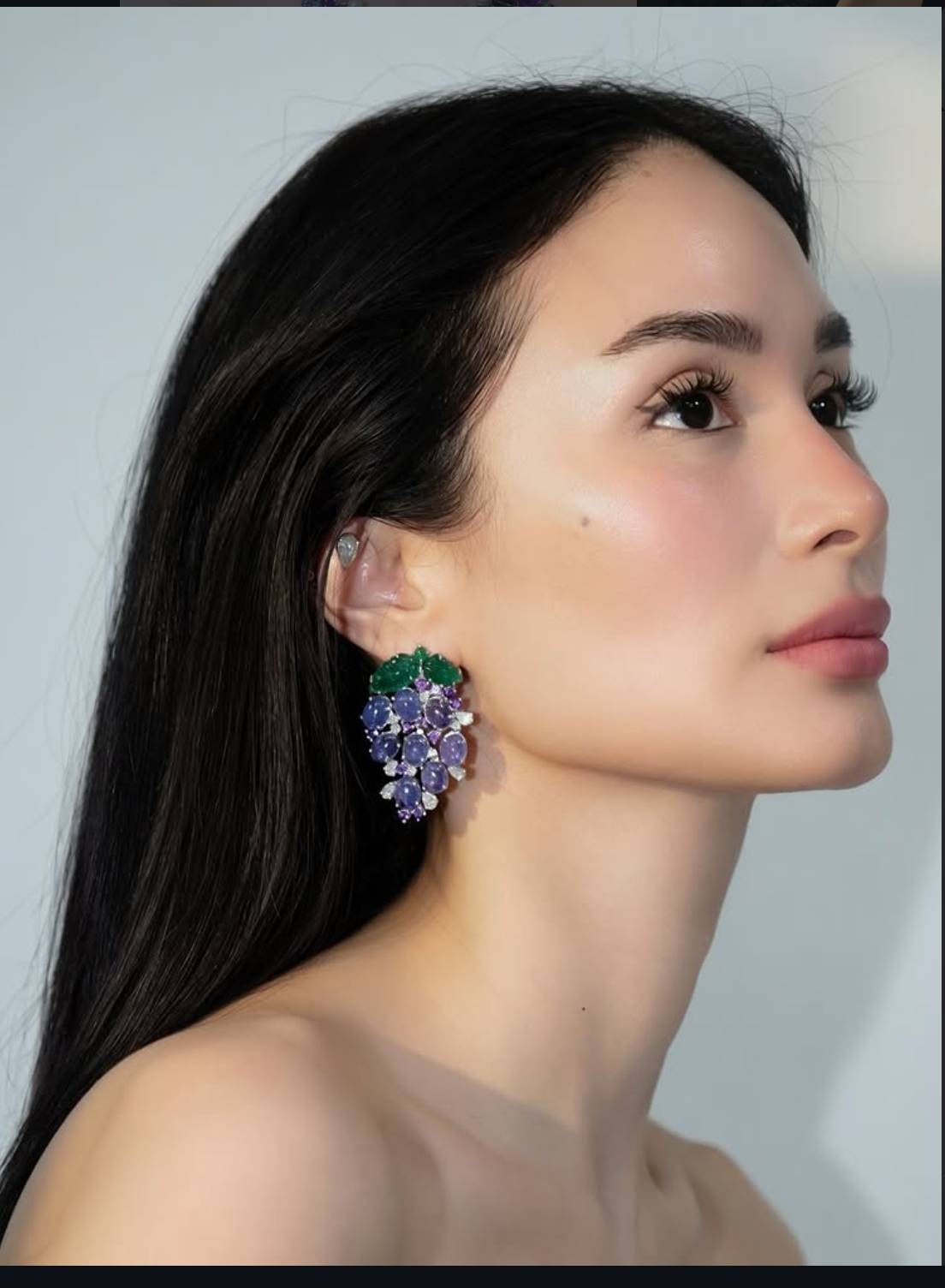 EARRINGS featuring a cluster of purple-blue stones topped with green gemstone ‘leaves.’